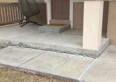 sinking sidewalk in front of porch - colorado